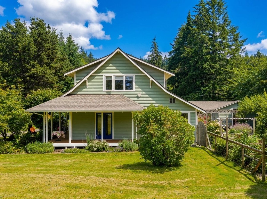 Green farmhouse exterior at Cove Cottage