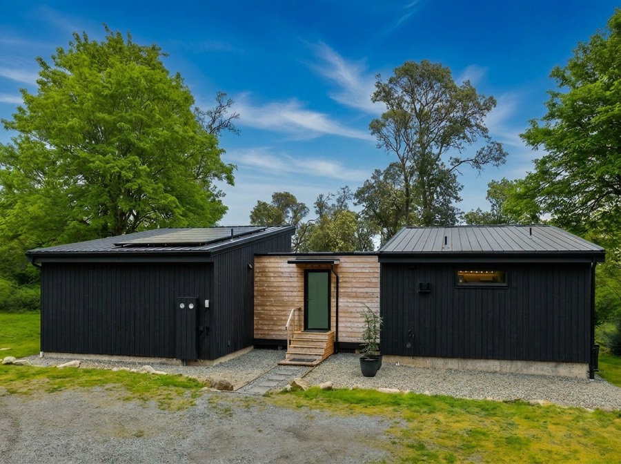 Black modern cabin exterior on Ridge Road